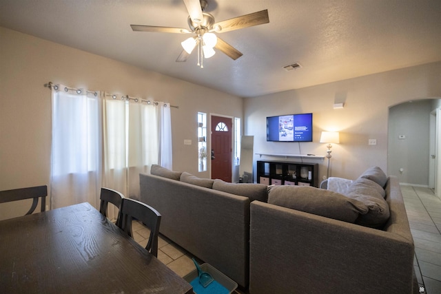 living room featuring ceiling fan and light tile patterned floors