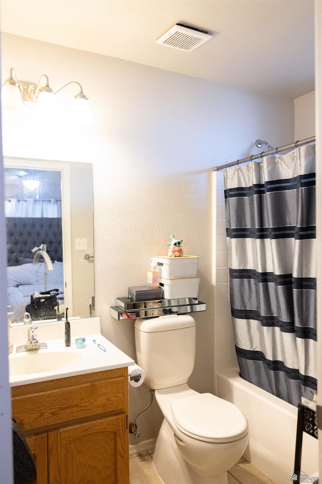 full bathroom with vanity, shower / bath combo with shower curtain, and toilet