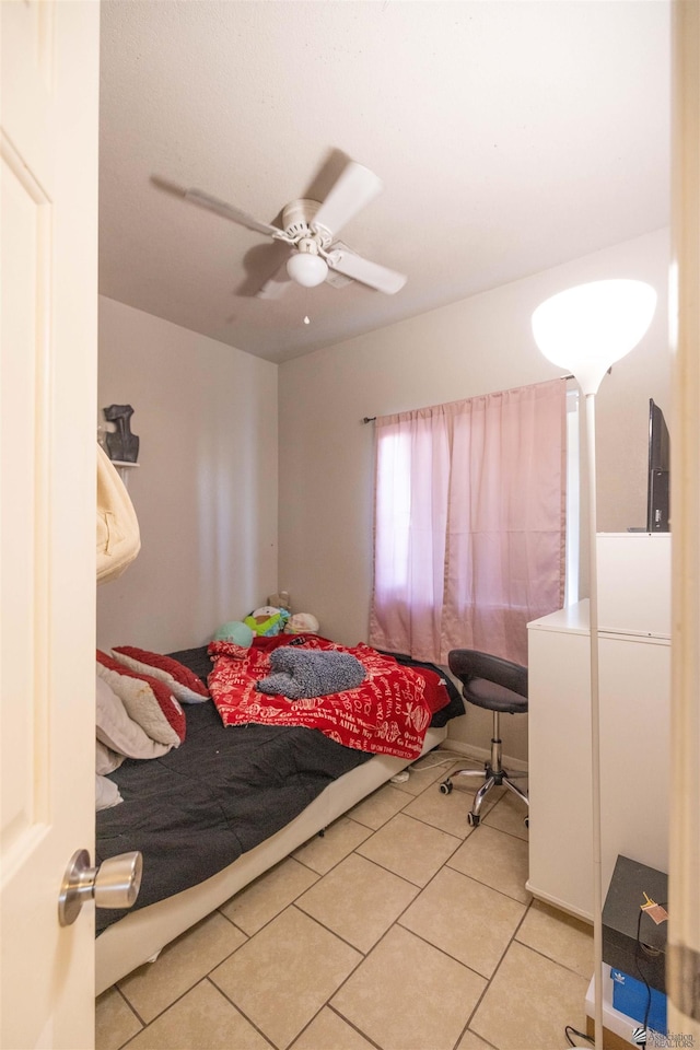 tiled bedroom featuring ceiling fan