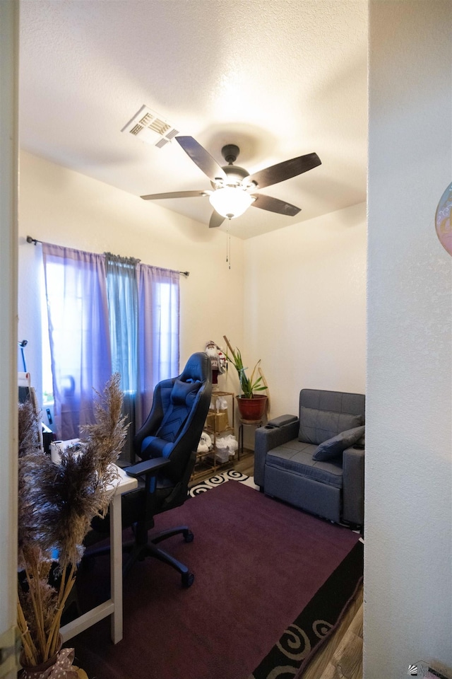 home office featuring hardwood / wood-style floors and ceiling fan