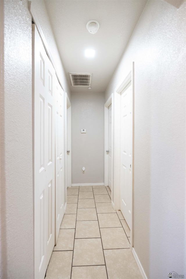 corridor with light tile patterned floors