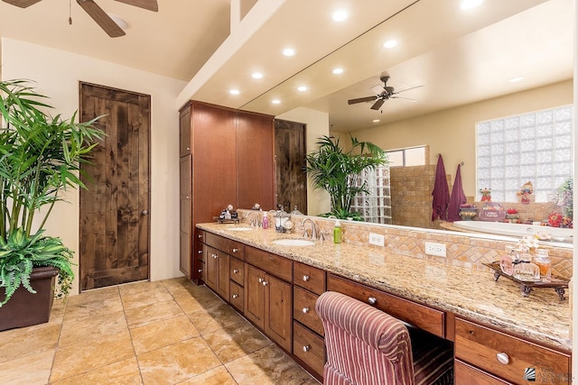 bathroom featuring vanity, ceiling fan, and a bath