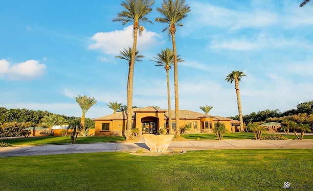 mediterranean / spanish house with a front yard