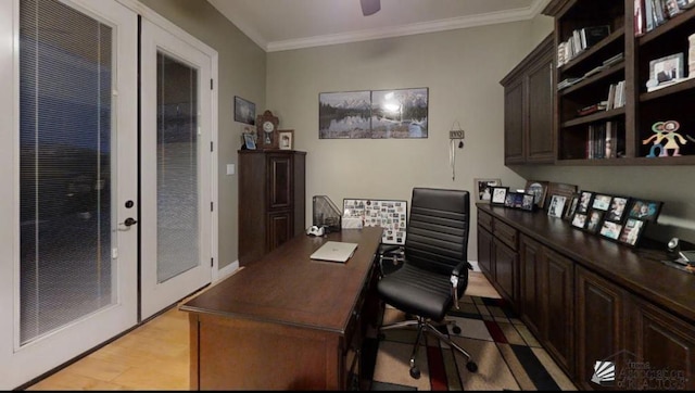 home office with crown molding, french doors, and light wood-type flooring