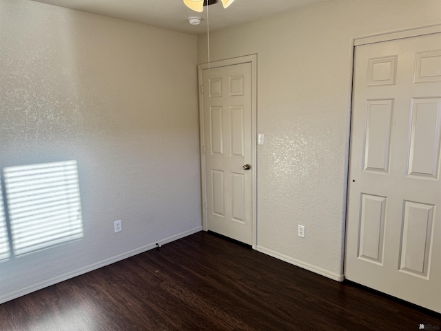 unfurnished bedroom with dark hardwood / wood-style floors