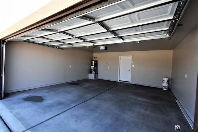 garage featuring strapped water heater and a garage door opener