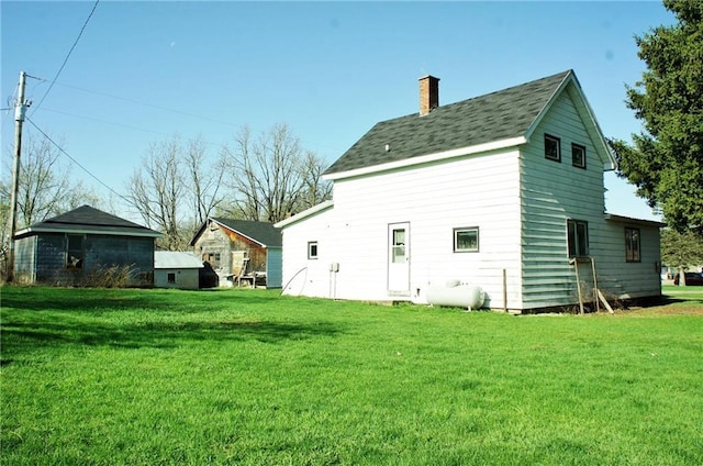 rear view of property with a lawn