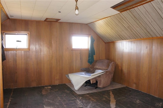 additional living space featuring wood walls and vaulted ceiling