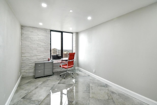 office area with light tile flooring, expansive windows, and tile walls