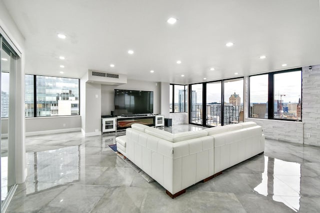 living room featuring expansive windows, a wealth of natural light, and light tile floors