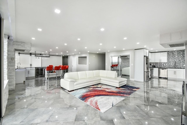 living room featuring marble finish floor, beverage cooler, visible vents, and recessed lighting