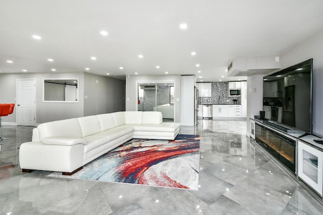 living area featuring marble finish floor and recessed lighting