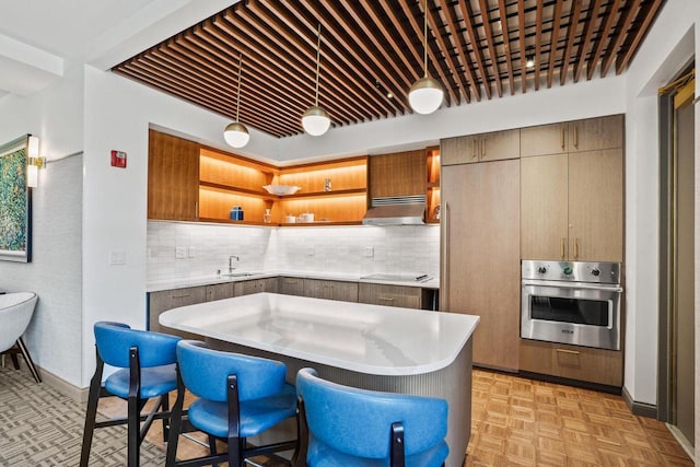 kitchen featuring open shelves, exhaust hood, light countertops, stainless steel oven, and black electric cooktop