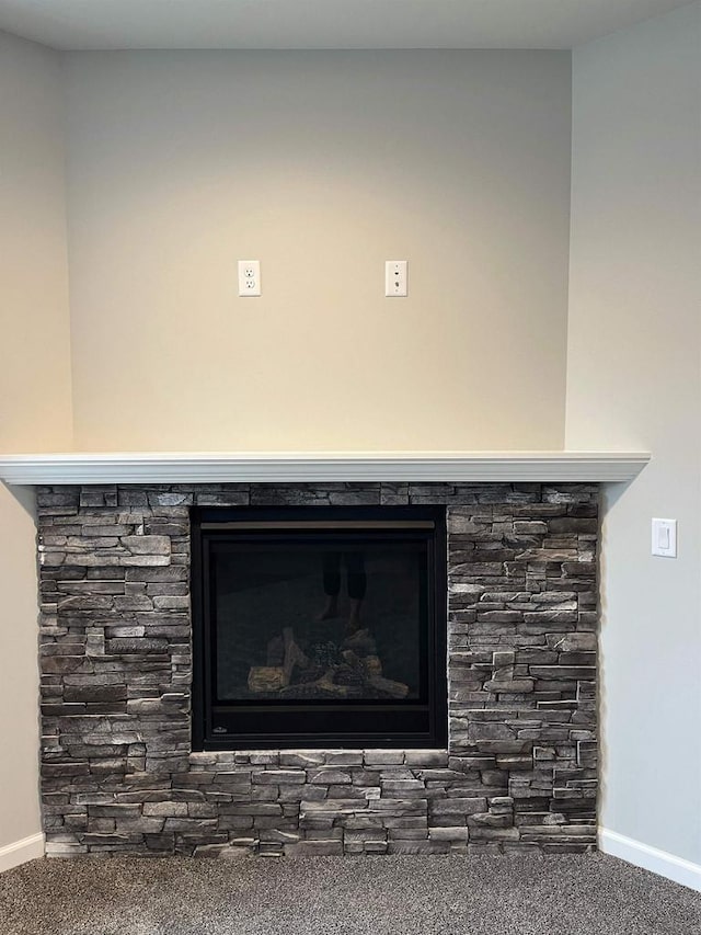 room details with carpet floors and a fireplace