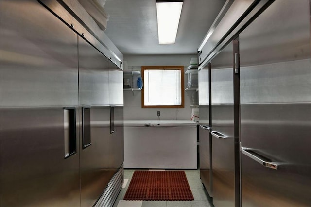 interior space with light tile flooring and high quality fridge