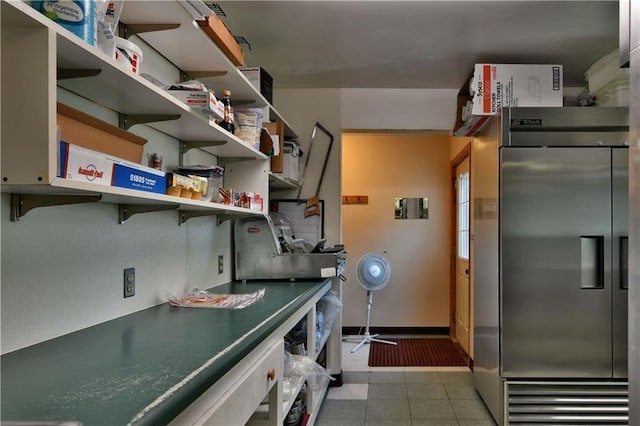 clothes washing area featuring light tile floors