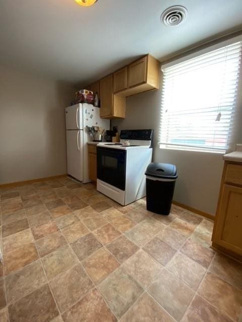 kitchen featuring white appliances and light tile floors