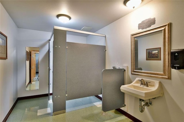 bathroom with tile flooring and sink