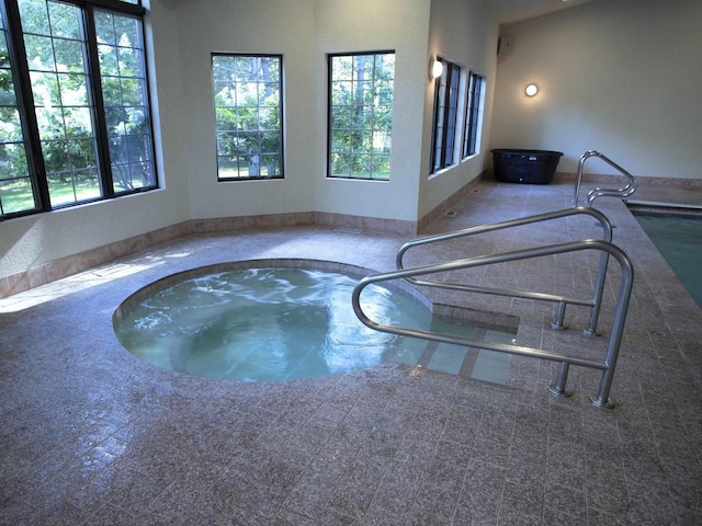 view of swimming pool with an indoor in ground hot tub