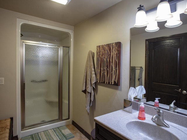 bathroom with vanity and a shower with door