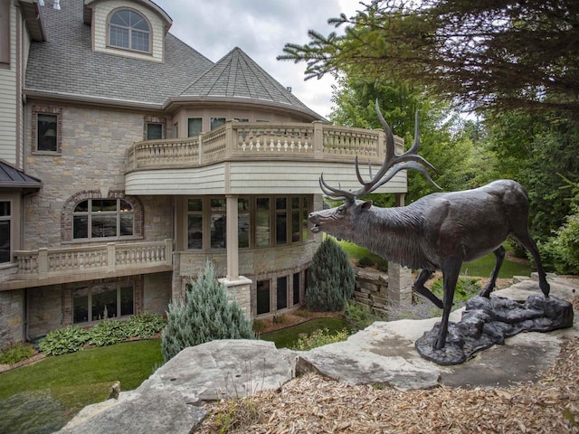 back of property featuring a balcony