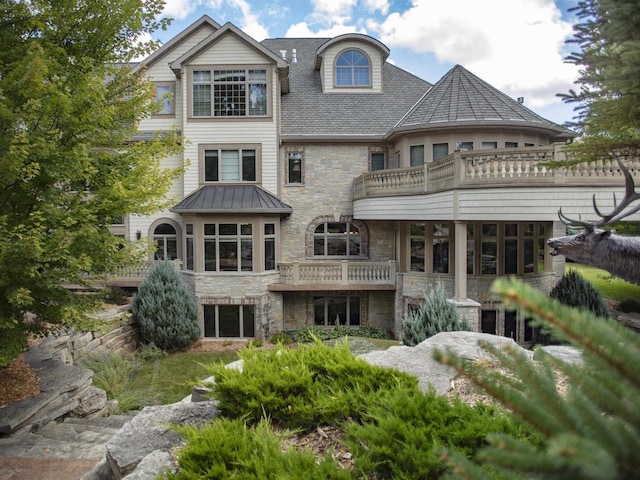 view of front of house featuring a balcony