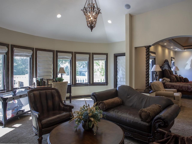 carpeted living room featuring an inviting chandelier