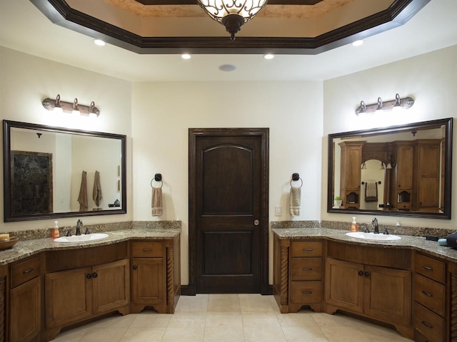 bathroom with double sink vanity, tile floors, and a tray ceiling