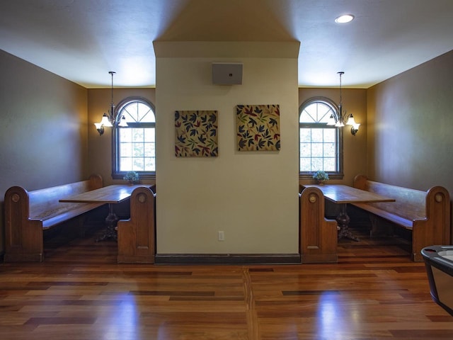 kitchen featuring decorative light fixtures, a notable chandelier, and dark hardwood / wood-style flooring