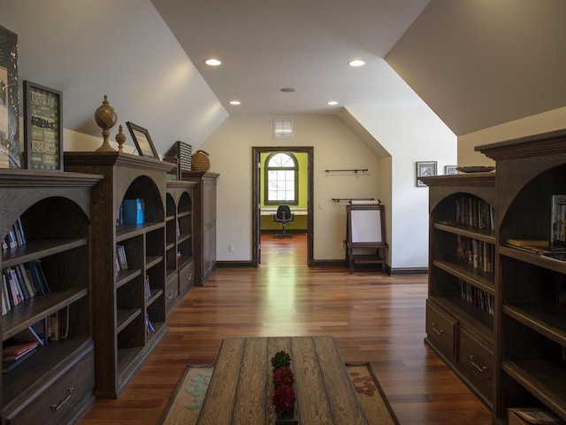 sitting room with dark wood-type flooring and vaulted ceiling