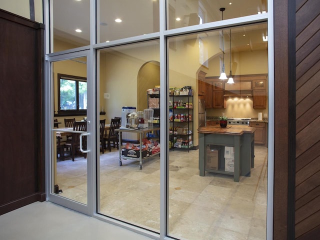 entryway with ceiling fan and a high ceiling