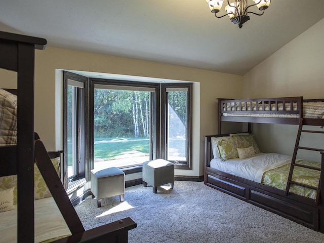 carpeted bedroom with a notable chandelier and vaulted ceiling