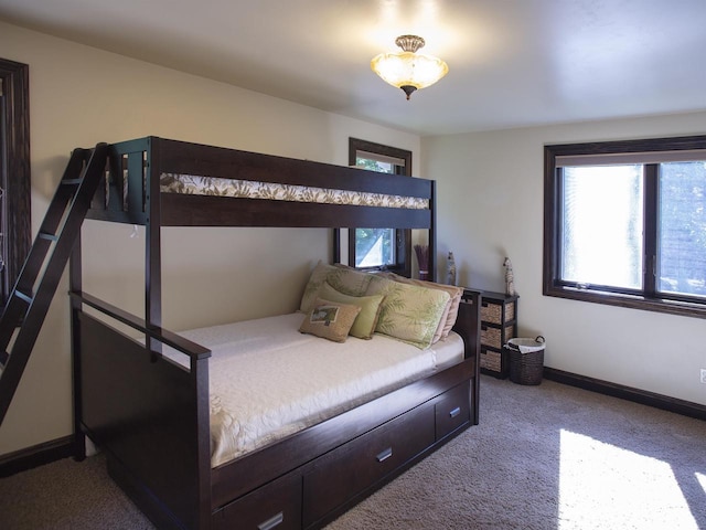 bedroom with multiple windows and light carpet