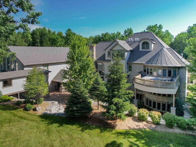 rear view of property with a yard