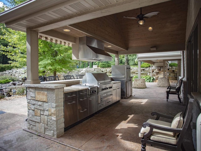 view of patio featuring a grill, exterior kitchen, and ceiling fan