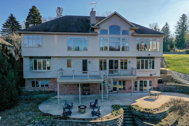 rear view of property featuring central AC unit and a patio