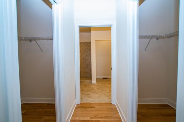 spacious closet featuring light hardwood / wood-style floors