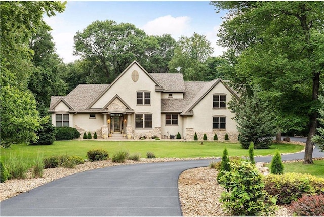 french country home featuring a front lawn