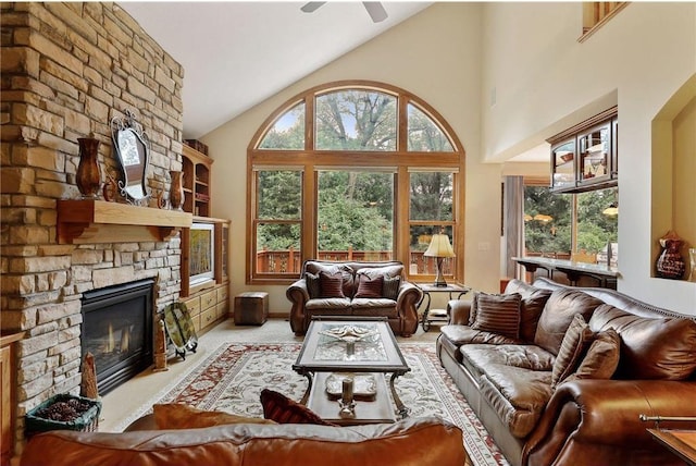 living room with a fireplace, a wealth of natural light, light carpet, and high vaulted ceiling