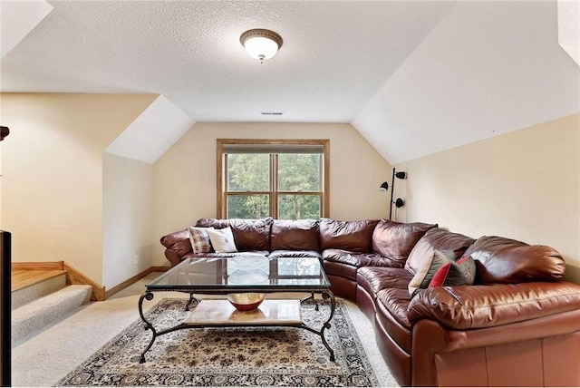 carpeted living room with lofted ceiling and a textured ceiling