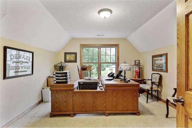 carpeted home office featuring lofted ceiling and a textured ceiling