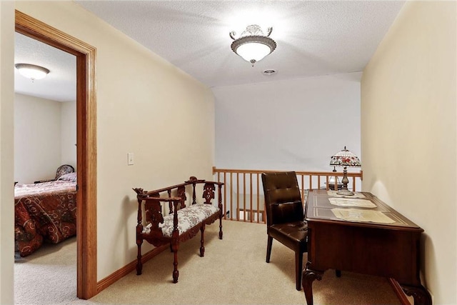 carpeted office space featuring a textured ceiling