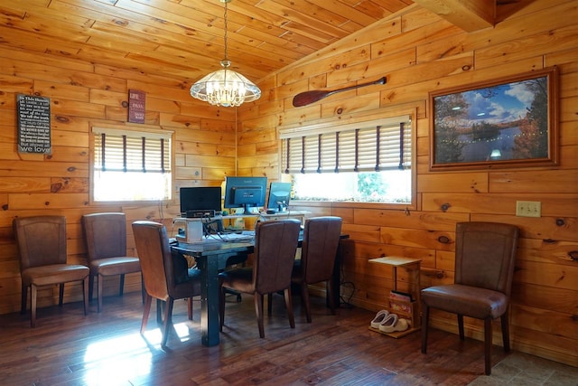 dining space with a chandelier, plenty of natural light, vaulted ceiling, and dark hardwood / wood-style flooring