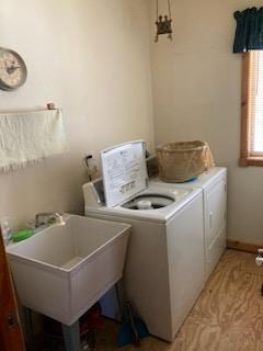 laundry room with washer and clothes dryer and sink