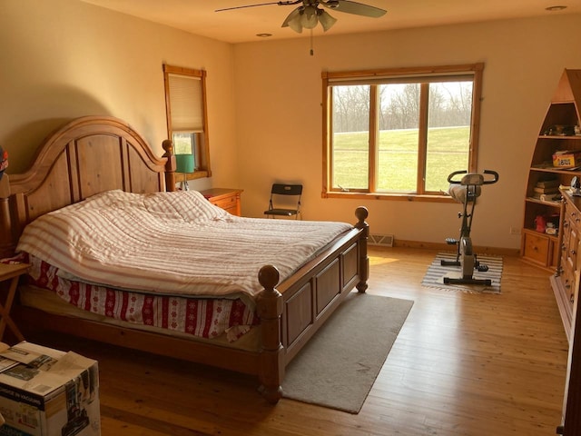 bedroom featuring light hardwood / wood-style floors and ceiling fan