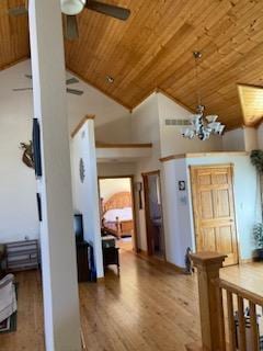 interior space with a notable chandelier, hardwood / wood-style floors, wood ceiling, and high vaulted ceiling