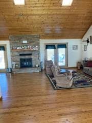 living room featuring lofted ceiling, wood-type flooring, and a wealth of natural light