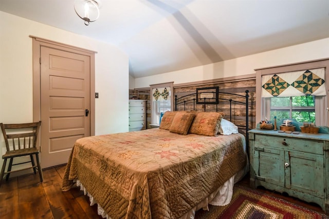 bedroom with dark wood-type flooring and vaulted ceiling