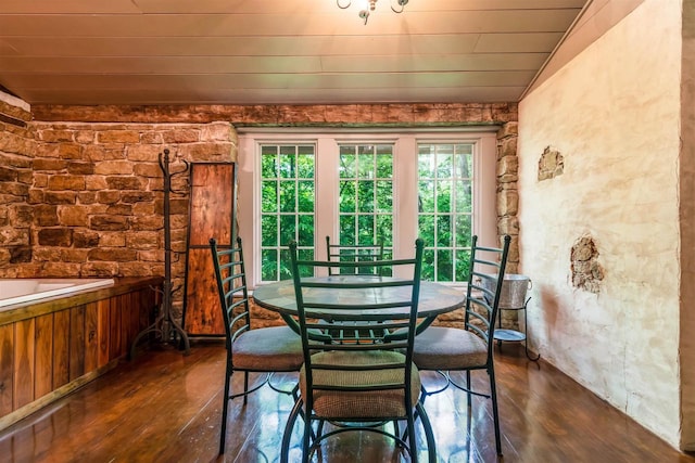 dining room with dark hardwood / wood-style flooring and vaulted ceiling