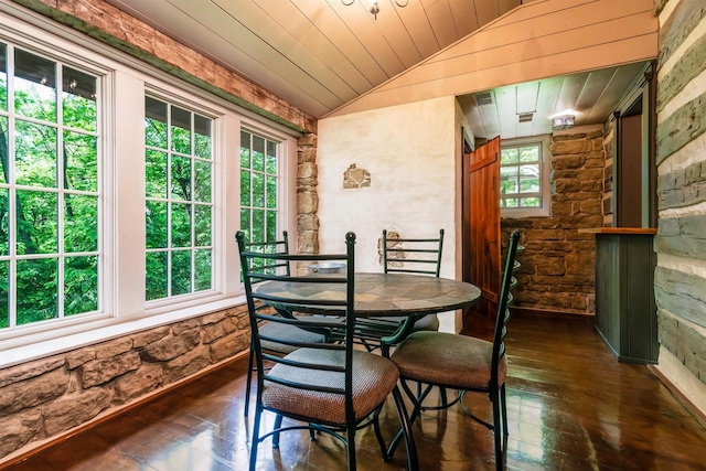 dining area featuring wooden ceiling, vaulted ceiling, a wealth of natural light, and dark hardwood / wood-style floors